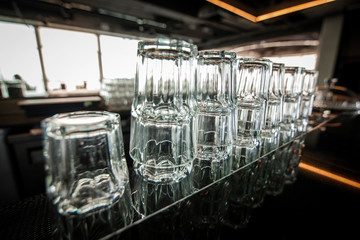 Fototapeta na wymiar Inverted glasses on the kitchen bar, many glasses