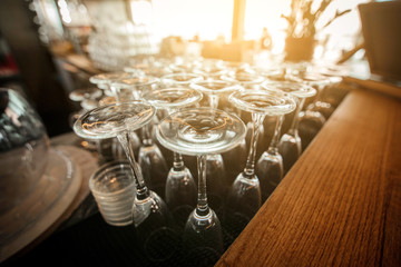 Empty inverted glasses on a table  in a restaurant. Toned