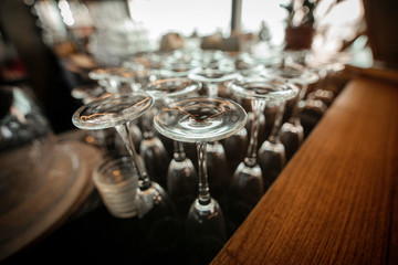 Empty inverted glasses on a table  in a restaurant. Toned