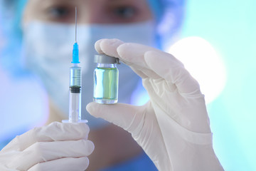 Fototapeta premium Doctor holding syringe and medicine for vaccination, closeup