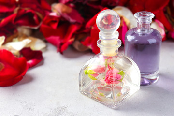 Obraz na płótnie Canvas Bottles with perfume oil on table
