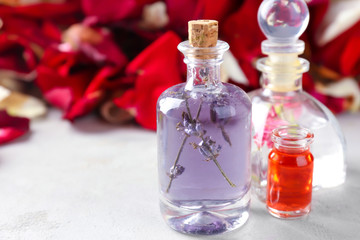 Obraz na płótnie Canvas Bottles with perfume oil on table