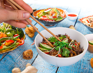 Various of asian meals on rustic background.