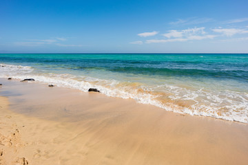 Fototapeta na wymiar wave of blue ocean on sandy beach. Background.