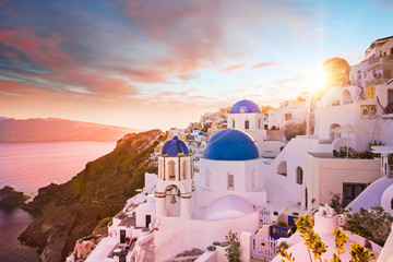 Sunset view of the blue dome churches of Santorini, Greece.