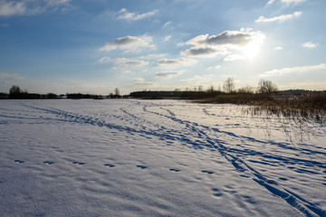 footpath in snow over frozen lake in countryside