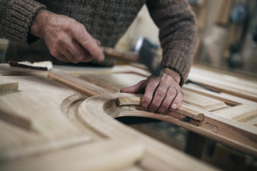 Close up shot of old master carpenter working in his woodwork or workshop