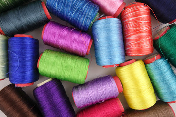 Multicolored accessories for sewing, bright threads, buttons and cloth