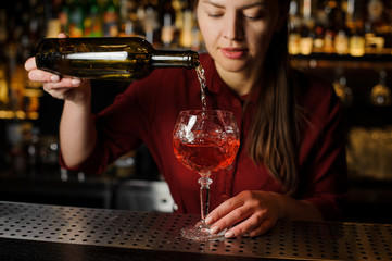 pretty barman girl prepares an alcoholic cocktail Spritz Veneziano