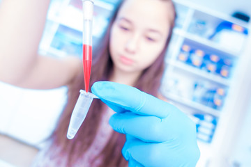Young woman with PCR props in genetics laboratory