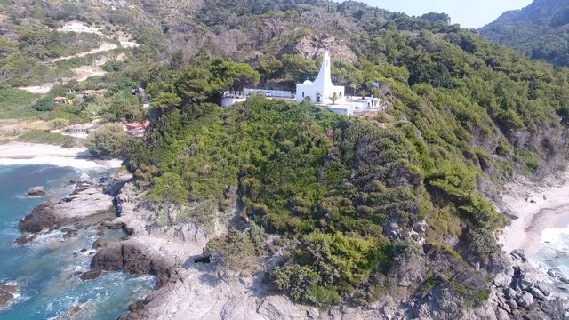 Chapel on the Cape. Aerial view of a white chapel on an exotic cape