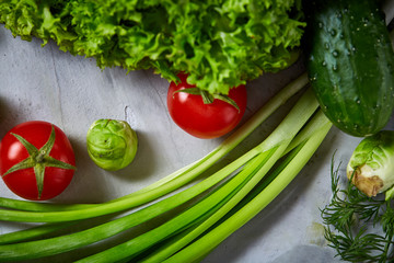 Fresh vegetables still life over white textured background, close-up, flat lay.