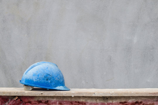 Blue hard hat on house building construction site