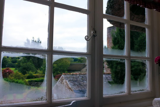 summer view from traditional English cottage wooden window