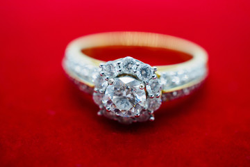 close up luxury wedding diamond ring on red background