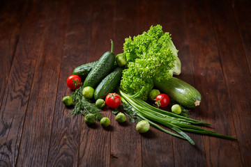 Fresh vegetables composition over wooden background, close-up, flat lay.