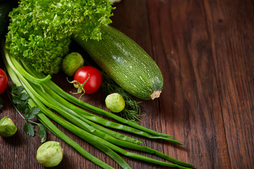 Fresh vegetables composition over wooden background, close-up, flat lay.