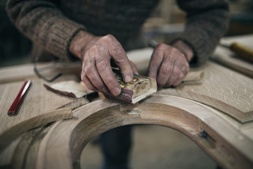 Close up shot of old master carpenter working in his woodwork or workshop
