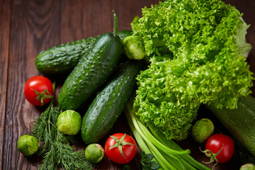 Fresh vegetables composition over wooden background, close-up, flat lay.