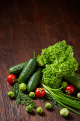 Fresh vegetables composition over wooden background, close-up, flat lay.