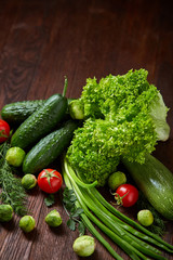 Fresh vegetables composition over wooden background, close-up, flat lay.