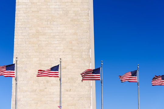 Americal Flags waving with Washington Monument Background, Washington DC, USA