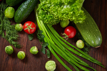 Fresh vegetables composition over wooden background, close-up, flat lay.