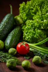 Fresh vegetables composition over wooden background, close-up, flat lay.
