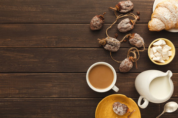 Coffee cup and sweets on vintage wooden table, top view