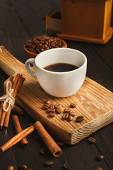 Morning coffee cup and spices on vintage wooden table