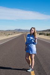 A pretty woman is standing in a road