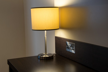 Yellow lamp on the desk, a hotel room interior