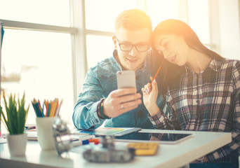 Cute creative designers working on new project in modern office