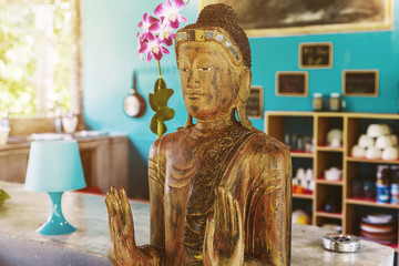 Wooden buddha statue like kitchen interior decor element