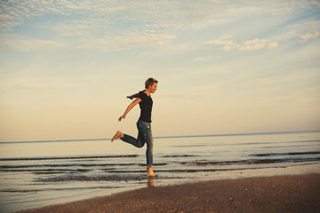 Young female with short hair have fun and enjoy on sea shore