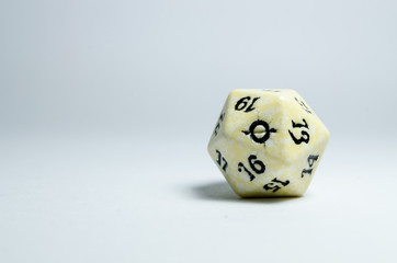 twenty-sided dice, isolated on a white background. Face of number twenty in focus. dice of role...