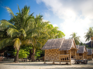 Fototapeta na wymiar Bamboo bungalow resort with coconut tree background on white sand beach in Horse shoe Island,Myanmar.