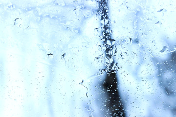 Spring. It's snowing and raining outside. The machine is photographed inside the machine. Background is blurred.