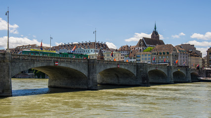 View of the Town of Basel with red stone Munster cathedral and the Rhine river.