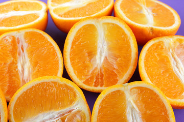 Fruit oranges on a purple background, a lot of orange halves for vegan, sliced citrus fruits for breakfast, fruit pop art pattern, vitamin set designer, juicy orange fruit, art