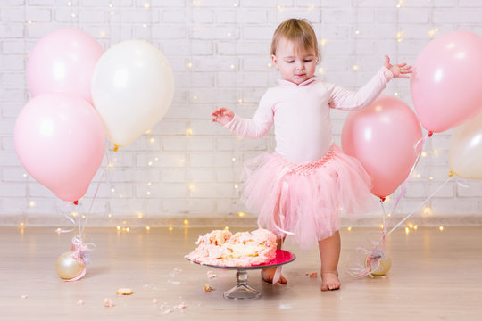 crashed party background - little girl and smashed cake over brick wall with lights and balloons