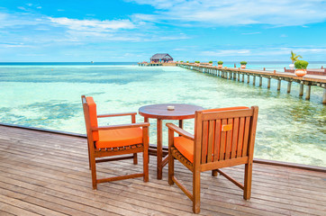 Restaurant on a wooden pier against the azure water of the ocean