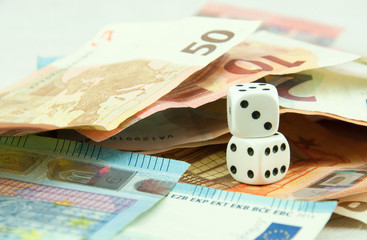 euro banknotes and coins with dice, europe future