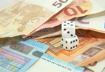 euro banknotes and coins with dice, europe future