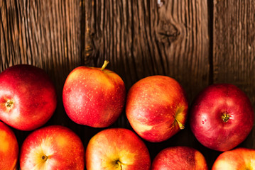 Background of apples whole and cut on wood