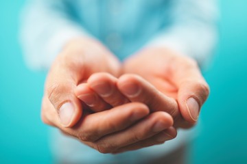 Male hands holding open palms