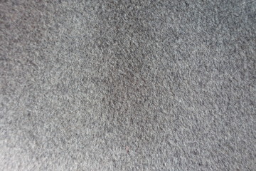 Fototapeta premium Texture of thick grey woolen coat fabric from above