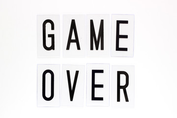 Game over text on white background. Concept for banners, web pages, games, presentation. Image top view.