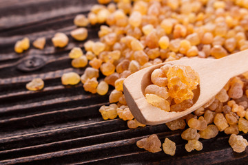 frankincense essential oil on a wooden background