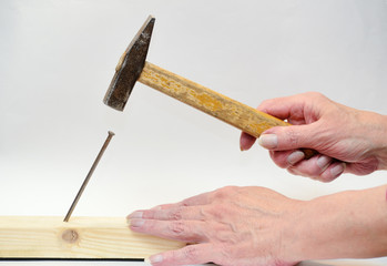 Hammer a nail into a Board.